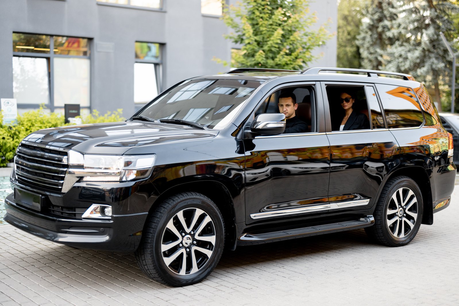 Businesswoman Driven by a Chauffeur in a Car 